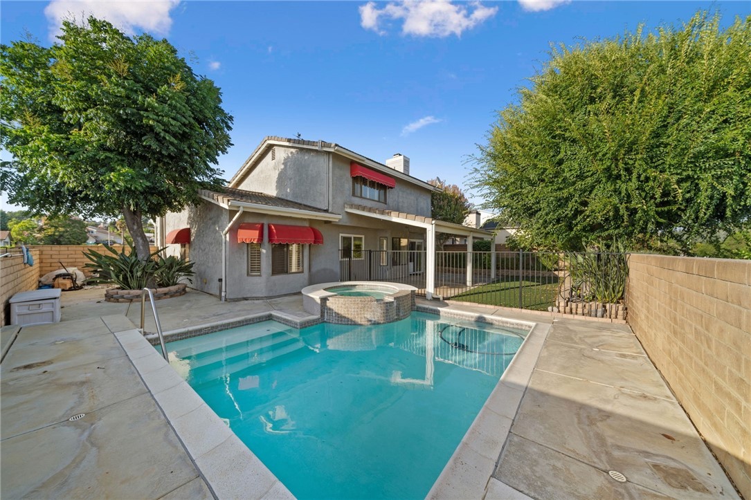 view of house with swimming pool outdoor seating