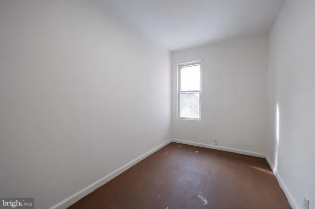 a view of a livingroom with wooden floor and an entryway