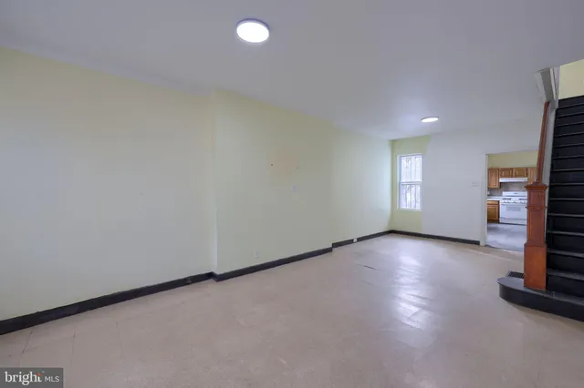 an empty room with a fireplace and window