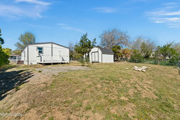 a view of a white house with a yard