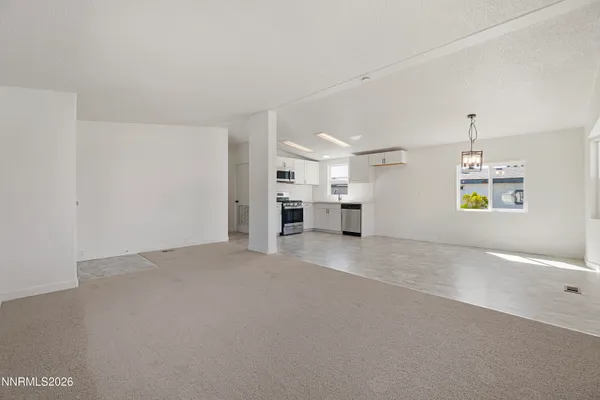 a view of empty room with furniture and a fireplace