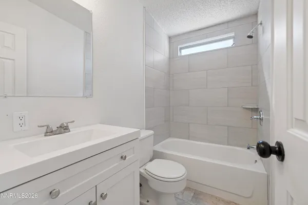 a bathroom with a sink a toilet and bathtub
