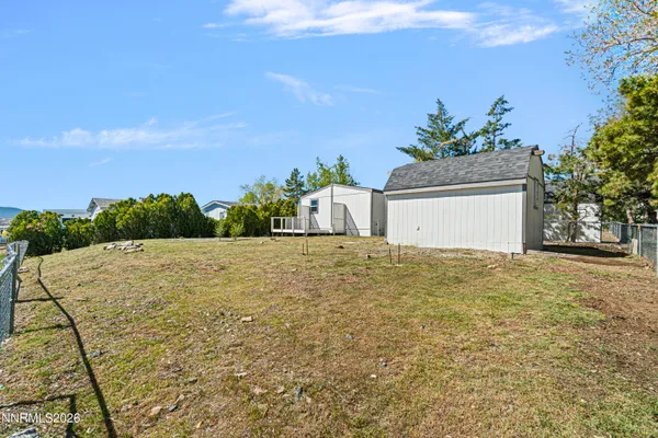 a white house with a yard and lake view
