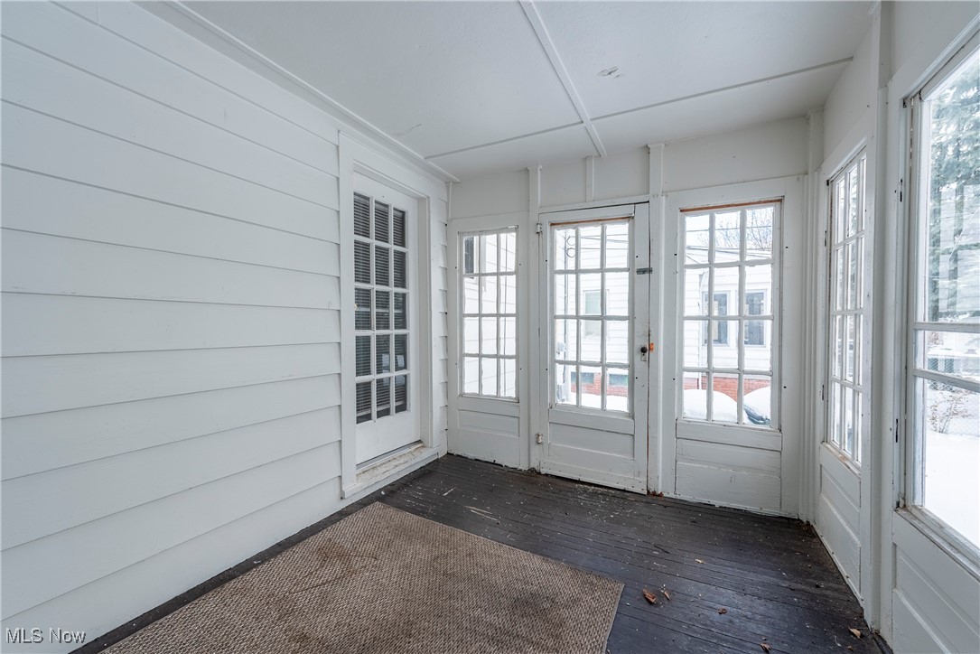 4041 Wilmington Road Cleveland, OH 44121 - Photo 27 of 38 Unfurnished sunroom with healthy amount of natural light, hardwood / wood-style floors, and wood walls