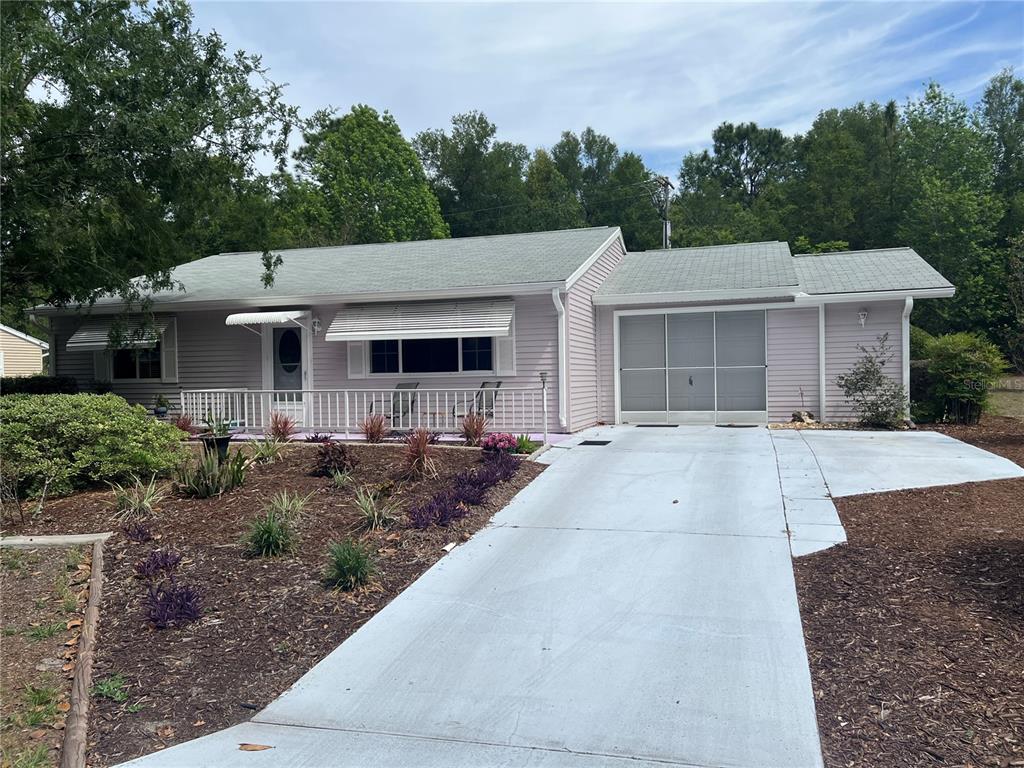 9021 Southwest 108th Place Ocala, FL 34481 - Photo 1 of 1 a front view of a house with a yard and garage