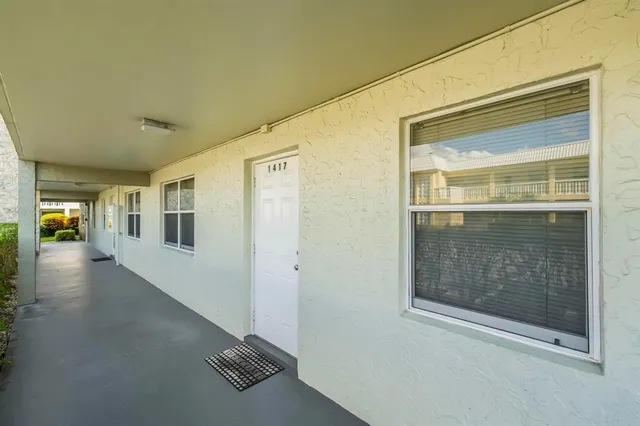a view of front door and porch with wooden floor