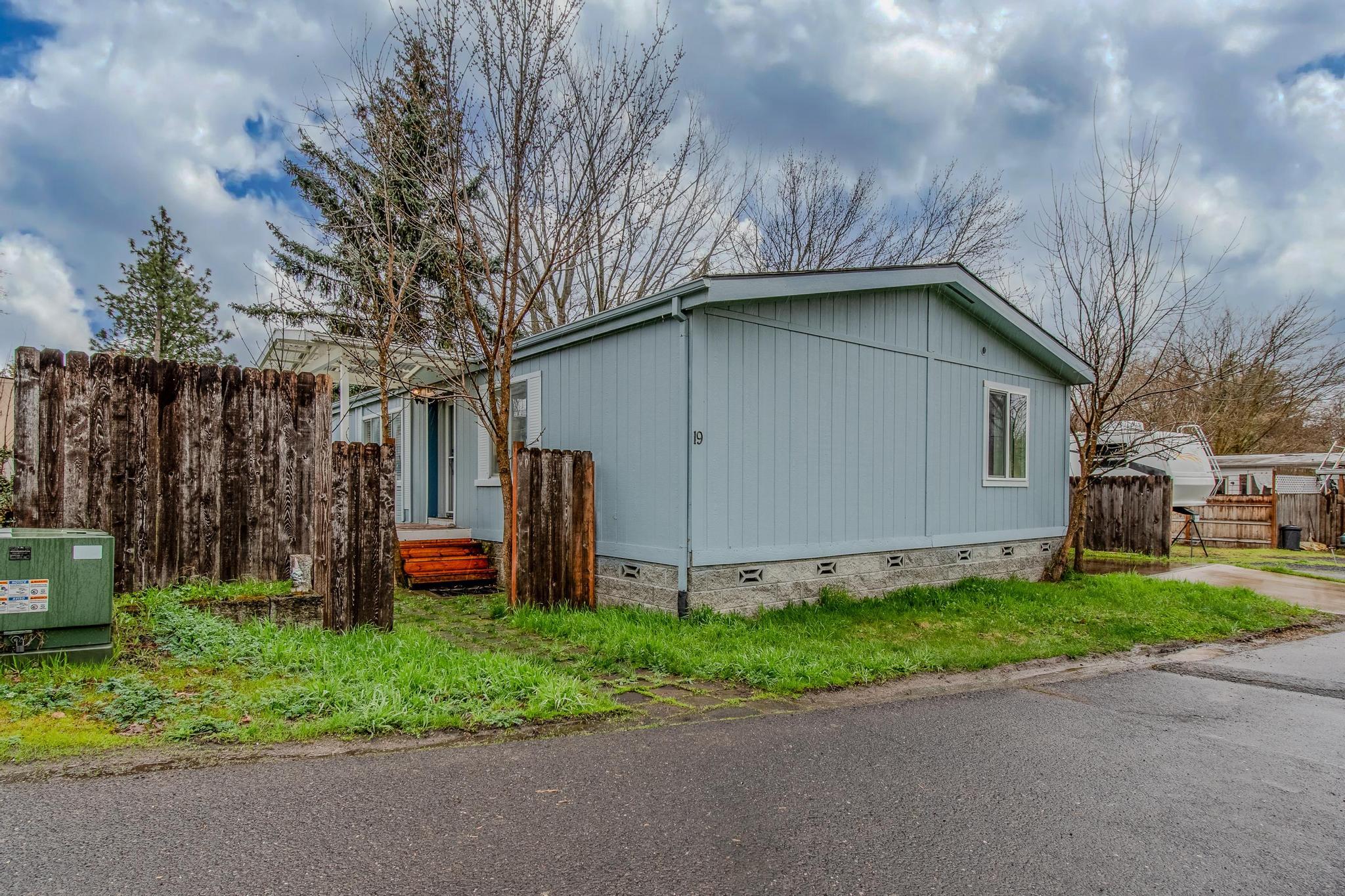 939 South Valley View Road, Unit 19 Ashland, OR 97520 - Photo 1 of 26 a front view of a house with garden