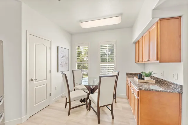 a dining room with granite countertop furniture and a window