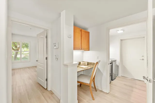 a view of a room with wooden floor windows and entryway