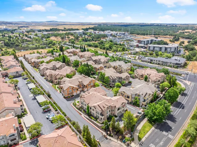 an aerial view of a city with lots of residential buildings lake and ocean view