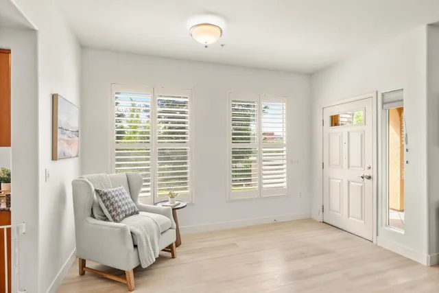 a view of a livingroom with furniture and a window