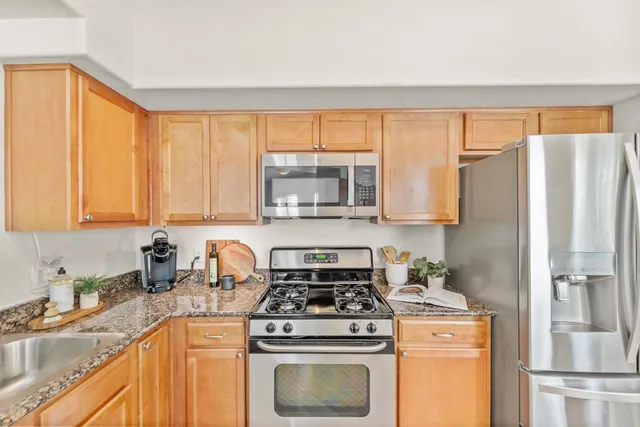 a kitchen with a stove a sink and a refrigerator
