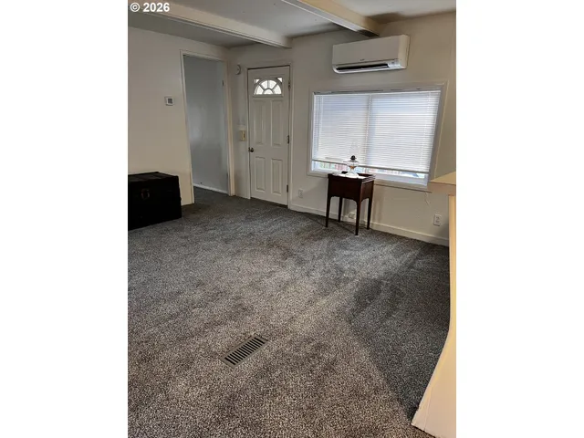 a view of a room with a bench and a window