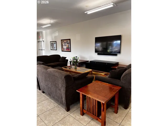 a room with pool table and windows