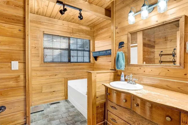 a bathroom with a sink mirror and a shower