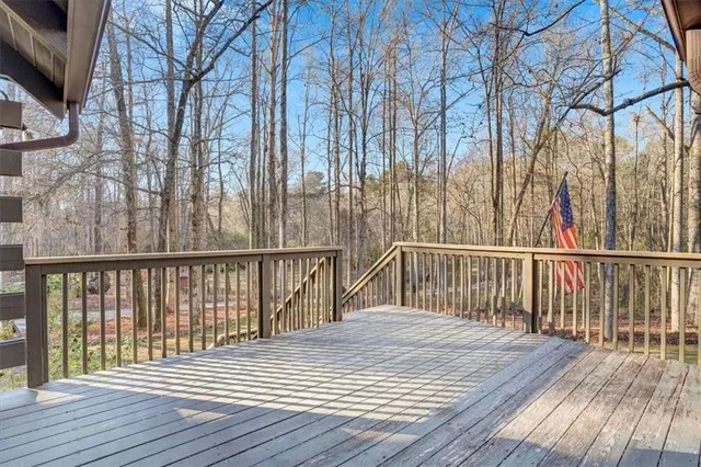 a balcony with wooden floor and fence