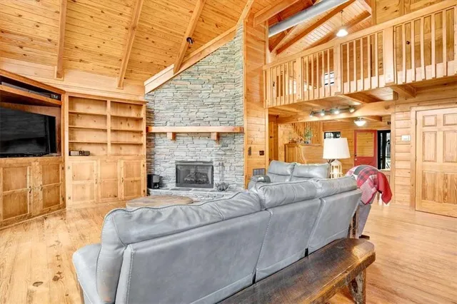 a living room with furniture a flat screen tv and a fireplace