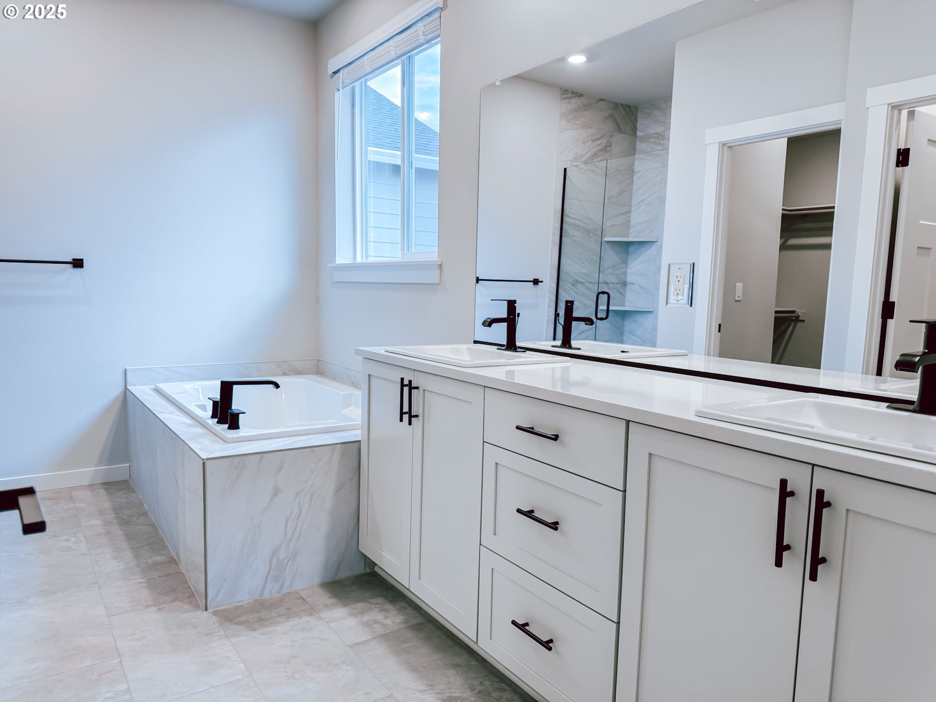 2509 South 4th Way Ridgefield, WA 98642 - Photo 23 of 45 a bathroom with a tub sink and mirror
