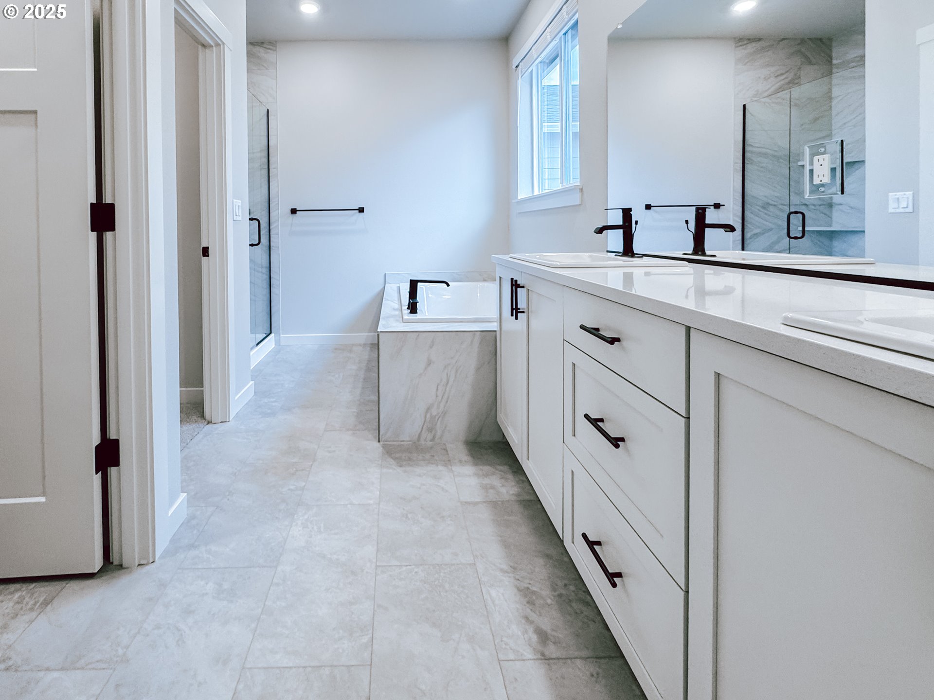 2509 South 4th Way Ridgefield, WA 98642 - Photo 24 of 45 a spacious bathroom with a double vanity sink a mirror and a bathtub
