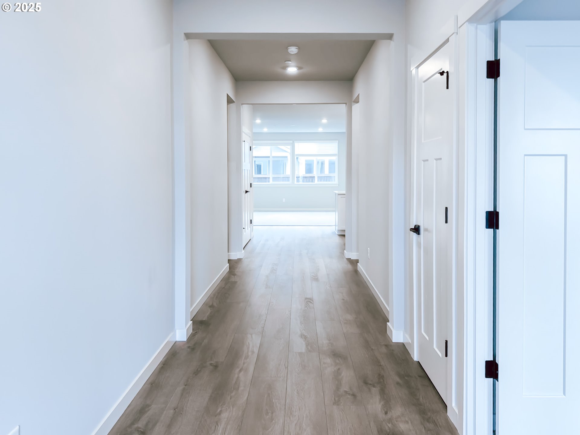 2509 South 4th Way Ridgefield, WA 98642 - Photo 3 of 45 a view of a hallway with wooden floor and a bathroom
