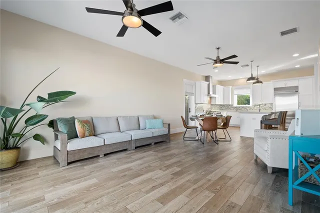 a dining room with furniture a rug and a chandelier