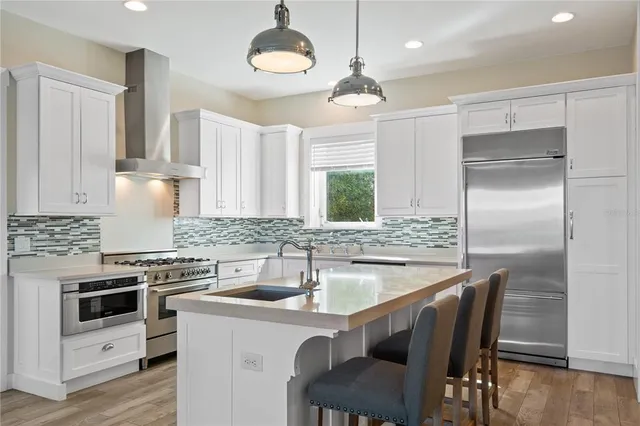 a kitchen with a sink stove and cabinets