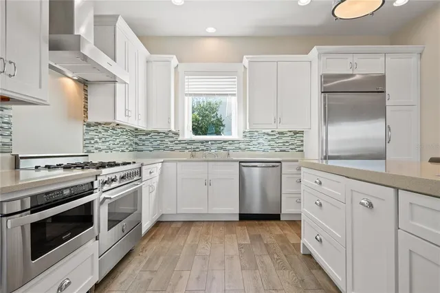 a kitchen with granite countertop stainless steel appliances and cabinets
