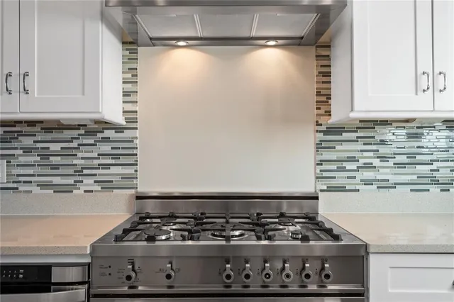 a kitchen with a dining table chairs sink and cabinets