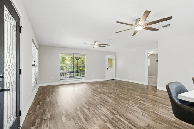 a living room with furniture and kitchen view