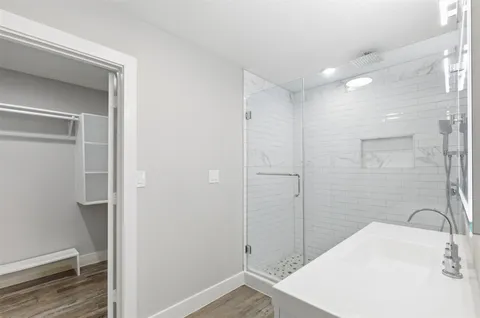 a bathroom with a sink a mirror toilet and bathtub