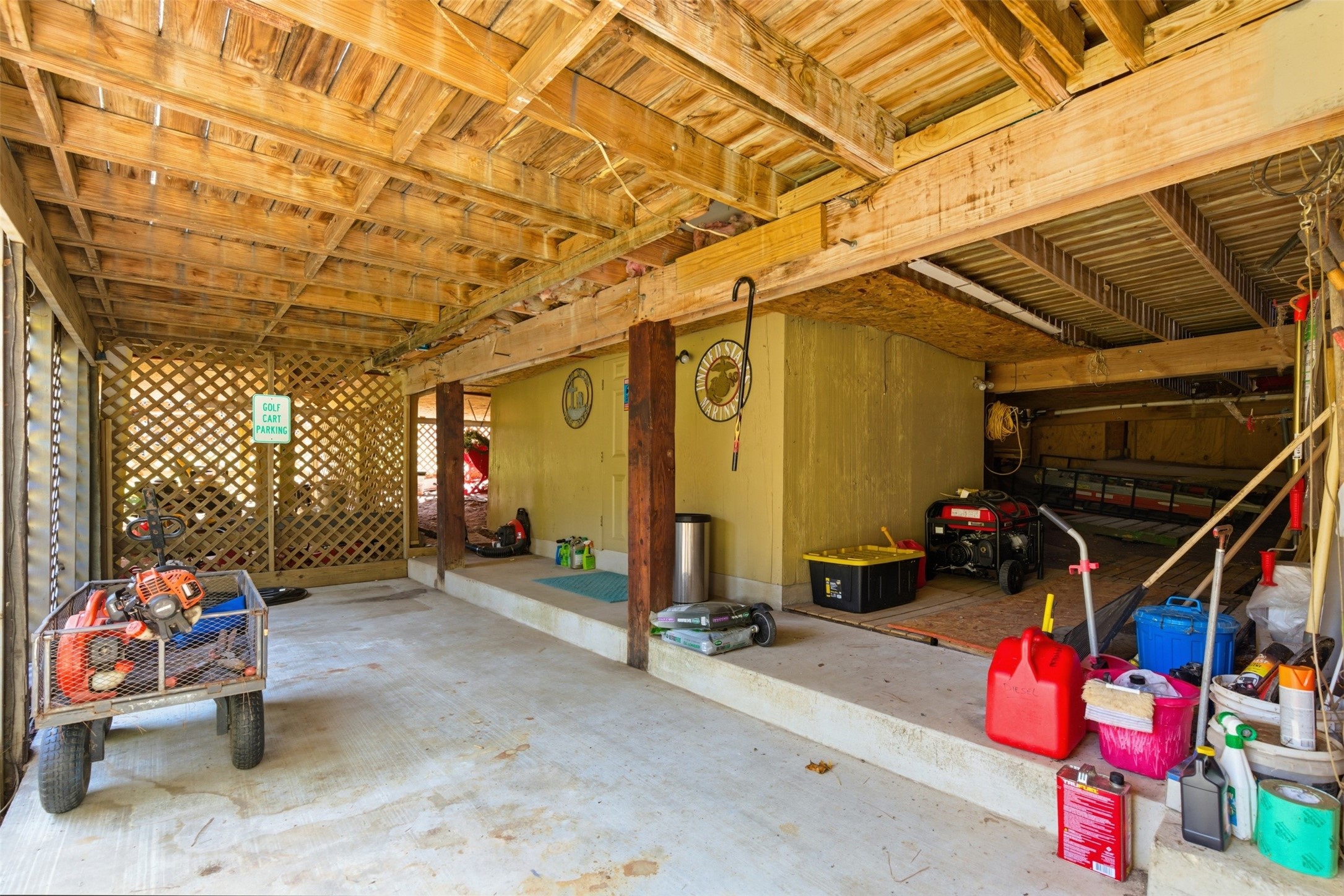 94 Gov Bell Drive Point Blank, TX 77364 - Photo 27 of 49 Double-door under-home storage with room for up to two golf carts, a lawn mower, and more — plus hidden inside, a versatile game room complete with a window unit AC. Perfect for a man-cave, she-shed, or any flex space you can imagine!