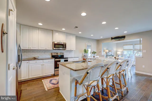 a kitchen with appliances a sink and cabinets