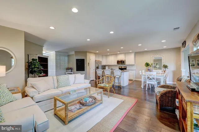 a living room with furniture kitchen view and a couch