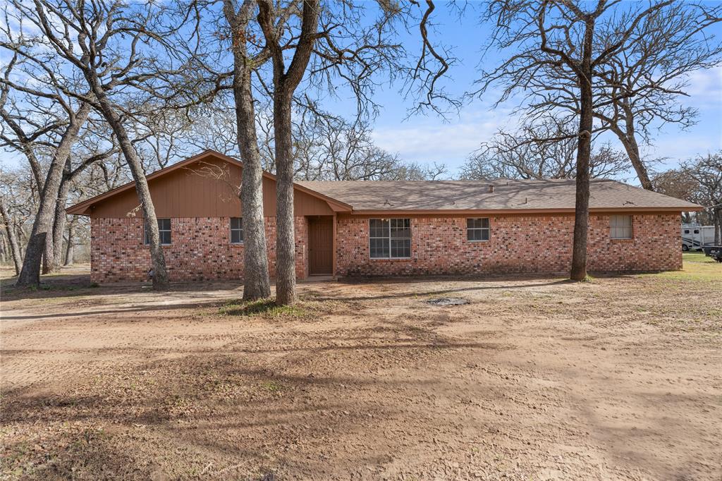 1447 Red Gate Road Mart, TX 76664 - Photo 3 of 38 a front view of a house with a yard and garage