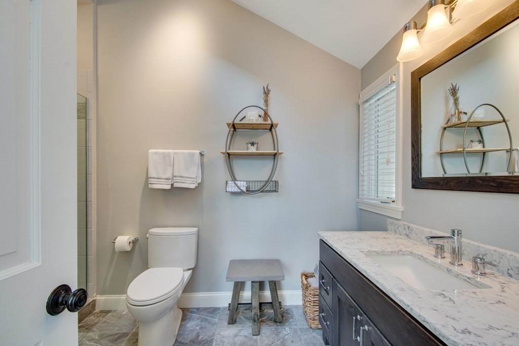 254 Broad Meadow Road Needham, MA 02492 - Photo 14 of 24 a bathroom with a granite countertop toilet sink and mirror