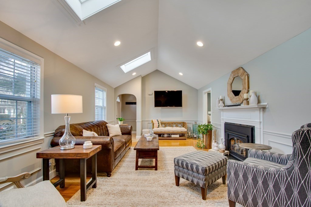 254 Broad Meadow Road Needham, MA 02492 - Photo 3 of 24 a living room with furniture a fireplace and a flat screen tv