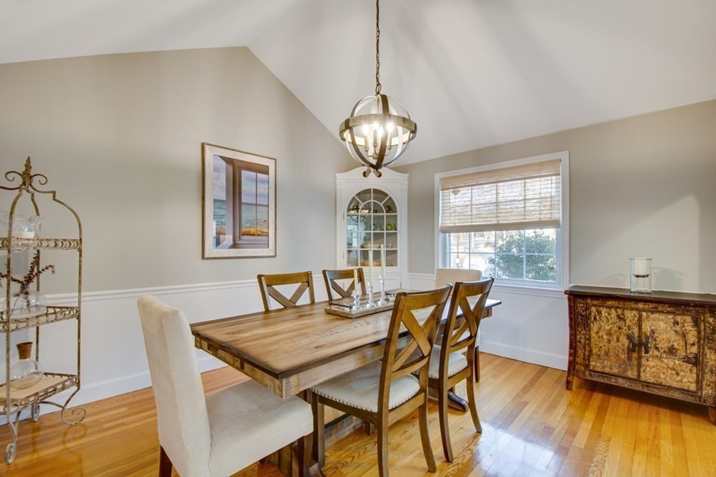 254 Broad Meadow Road Needham, MA 02492 - Photo 4 of 24 a view of a dining room with furniture a chandelier and wooden floor