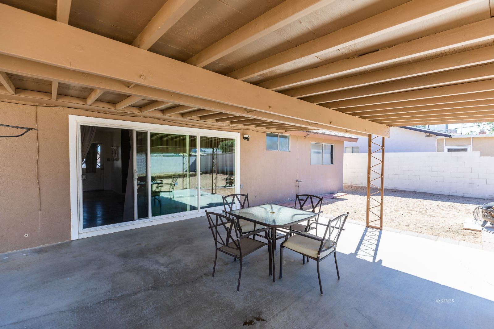 317 South Silver Ridge Street Ridgecrest, CA 93555 - Photo 26 of 28 a view of a patio with table and chairs and potted plants