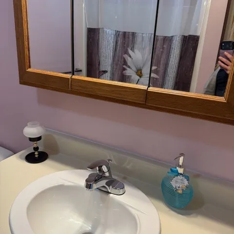 a room with wooden floor and pool table