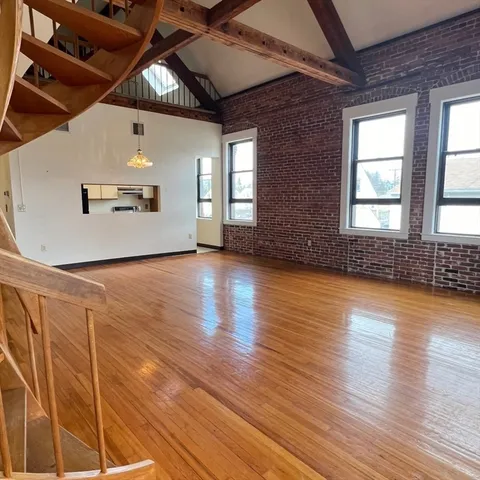 a view of an entryway with wooden floor