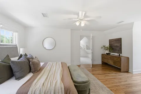 a bedroom with a bed and wooden floor