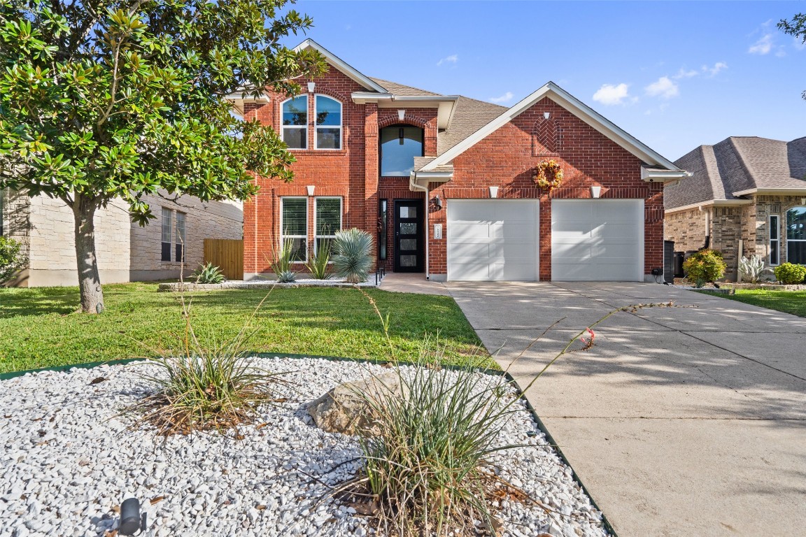 a front view of a house with a yard and garage
