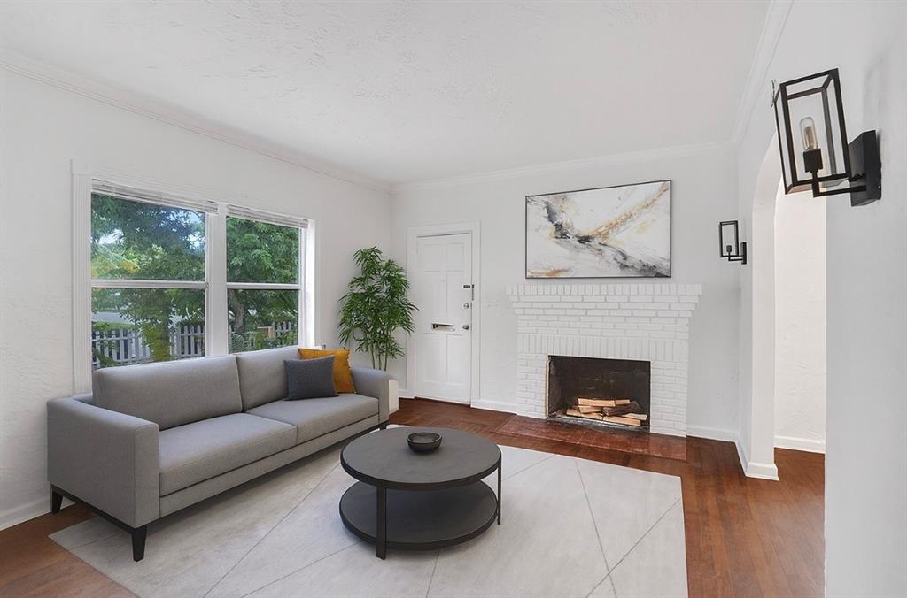 1818 Florida Avenue West Palm Beach, FL 33401 - Photo 11 of 50 a living room with furniture a fireplace and a large window