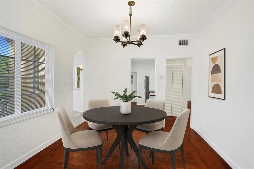 1818 Florida Avenue West Palm Beach, FL 33401 - Photo 17 of 50 a dining room with furniture a chandelier and wooden floor