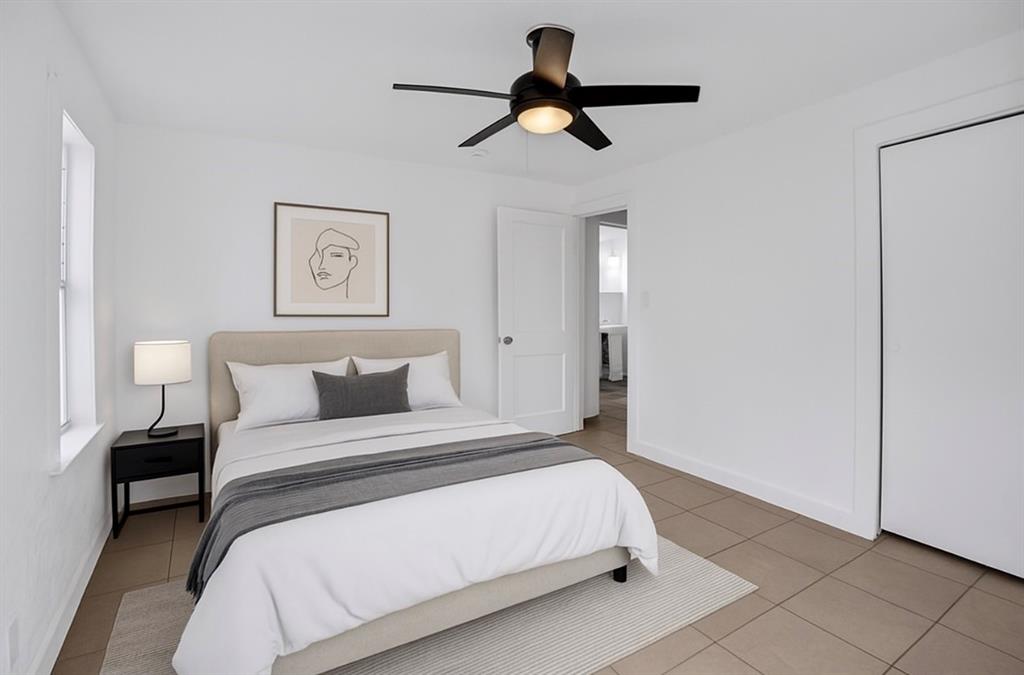 1818 Florida Avenue West Palm Beach, FL 33401 - Photo 32 of 50 a bedroom with a bed and a chandelier