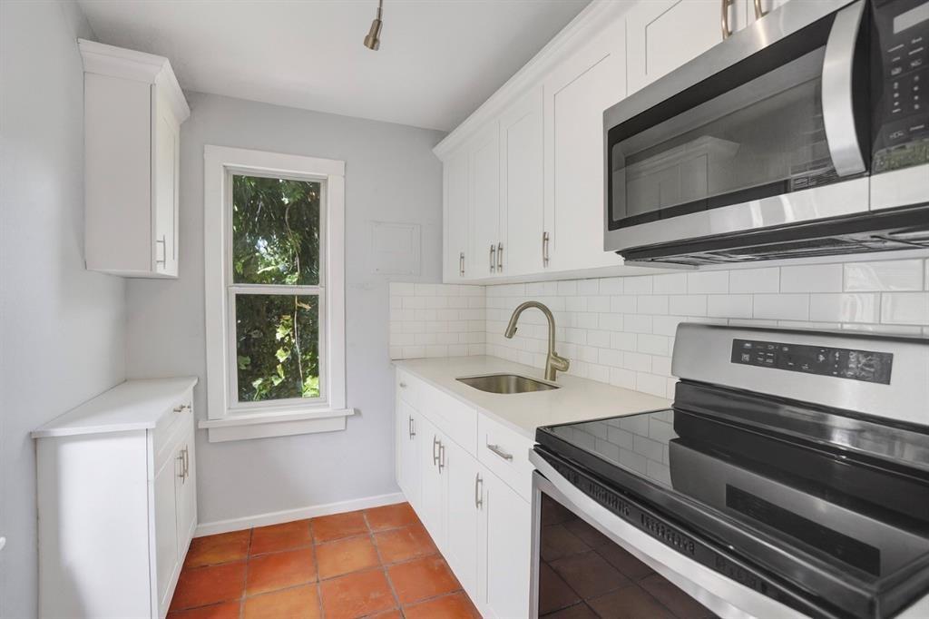 1818 Florida Avenue West Palm Beach, FL 33401 - Photo 39 of 50 a kitchen with stainless steel appliances granite countertop a sink and stove top oven