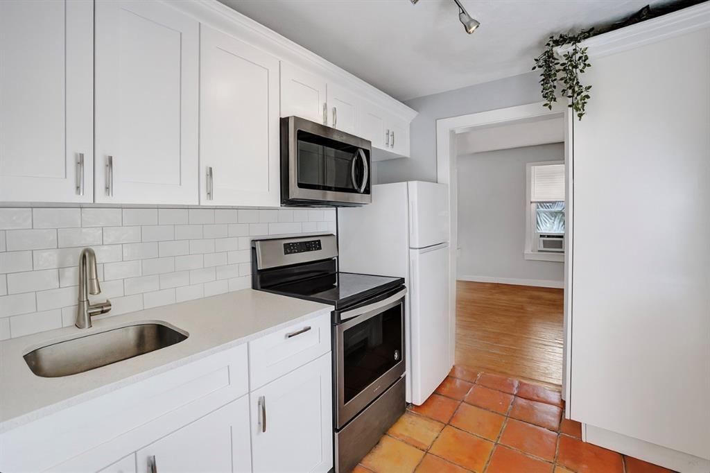 1818 Florida Avenue West Palm Beach, FL 33401 - Photo 40 of 50 a kitchen with stainless steel appliances granite countertop a sink and a stove