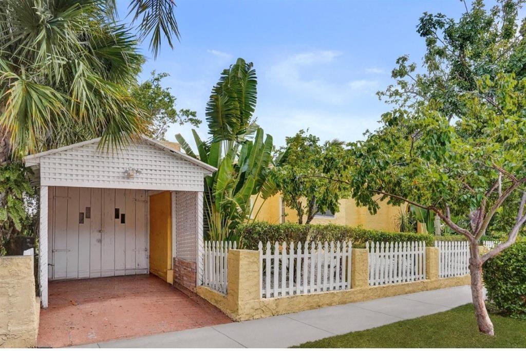 1818 Florida Avenue West Palm Beach, FL 33401 - Photo 9 of 50 a view of a house with a small yard and floor to ceiling window