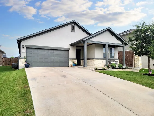 a front view of house with yard and green space