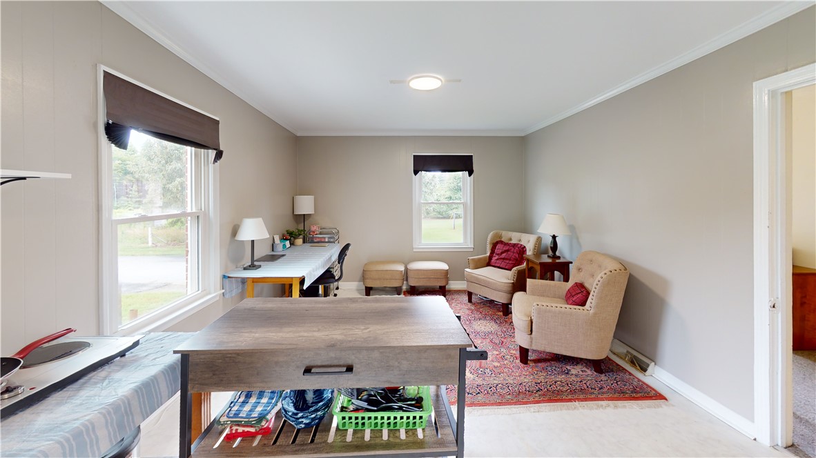 415 Church Street Pendleton, SC 29670 - Photo 11 of 35 A versatile living space offers ample natural light and an inviting atmosphere for both work and relaxation.